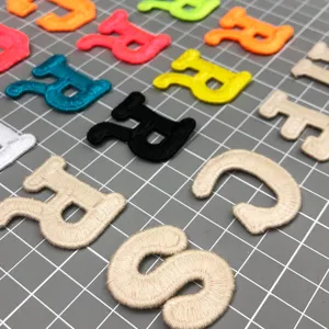Detailed shot of colorful embroidered gothic letter patches, ideal for hats, jackets and DIY.