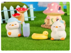Close-up view of cute spring duck miniature resin figurines for succulent garden decor details.