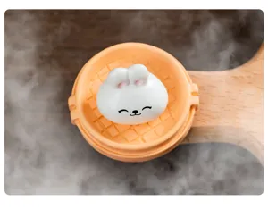 Miniature white rabbit bun toy in tiny orange steamer basket, perfect for dollhouse decoration.