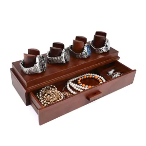 Wooden watch and jewelry organizer detail showing multi-tier display and storage drawer.