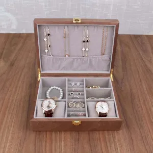 Wooden watch and jewelry storage box detail view featuring multi-compartment velvet interior.