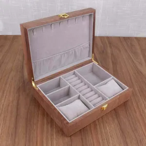 Wooden jewelry box interior detail, walnut finish, soft velvet lining, multiple compartments.