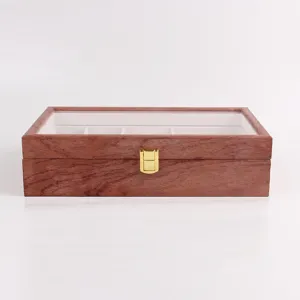 Wooden jewelry storage box detail view featuring a transparent lid and golden clasp.