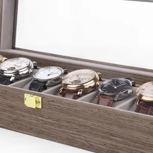 Wooden watch box detail showing wood grain texture, soft velvet slots and metal lock clasp.