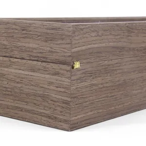 Close-up detail of the wooden watch box corner showing wood grain texture and hinge.