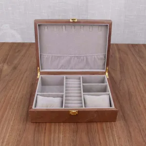 Wooden jewelry box with watch pillows, ring slots, and soft velvet lining for organized storage.