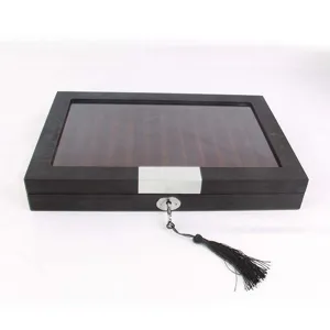 Detailed view of wooden fountain pen display box with clear glass lid and metal lock.
