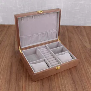 Wooden jewelry box with soft velvet interior, multi-compartment storage for rings and watches.