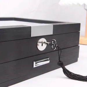 Close-up detail of the wooden fountain pen display storage box with metal lock key and clear lid.