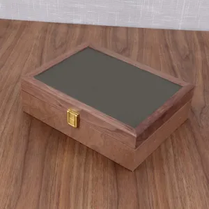 Wooden watch jewelry box detail, black walnut color storage box with golden metal lock clasp.