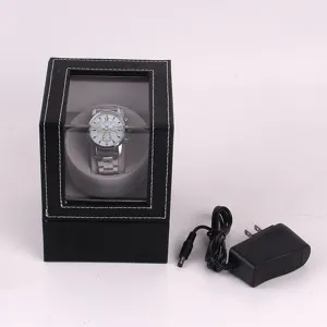 Detail view of black PU leather single watch winder with transparent window and power adapter.