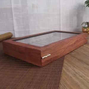Vintage wooden fountain pen display box detail showcasing 12 slots and glass cover.