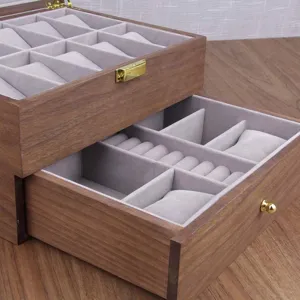 Detailed view of wooden double layer watch and jewelry storage box with soft grey velvet lining.