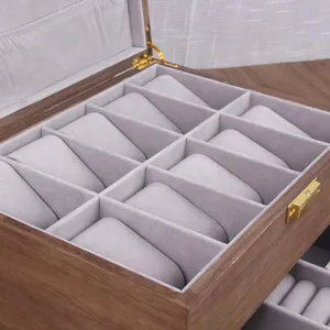 Detail view of wooden watch box interior with multiple velvet slots for jewelry storage.
