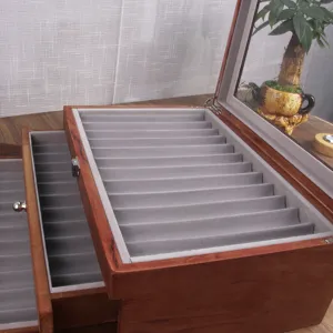 Detailed view of the multi-layer wooden fountain pen storage box with grey velvet slots.
