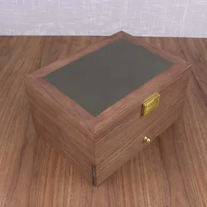 Detail view of solid wood watch and jewelry storage box, featuring walnut finish and gold hardware.