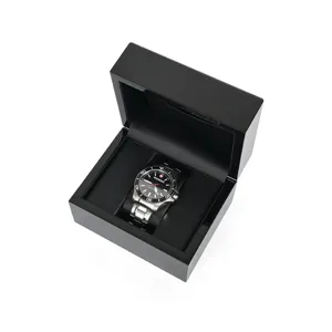 Black wooden watch box with gloss finish and soft black pillow for luxury gift presentation detail.