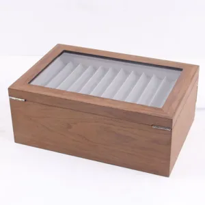 Wooden fountain pen display box detail showing the clear glass lid and neat pen slots inside.