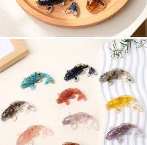 Detailed view of colorful resin koi fish ornaments with crystal stone chips, close-up display.