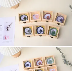 Detailed view of natural crystal gemstone bracelets with star charms in wooden boxes set.