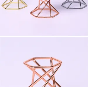 Detailed view of geometric metal crystal ball stand base, sleek modern iron display rack.