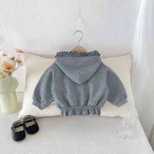 Grey baby toddler hooded jacket detail featuring cute ruffled hem and cozy knit texture.