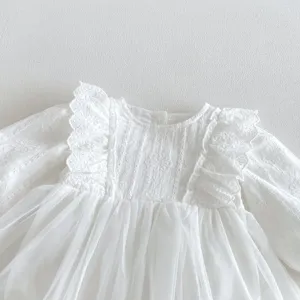 Detailed view of white baby girl long sleeve lace tulle romper, soft fabric, elegant princess style.