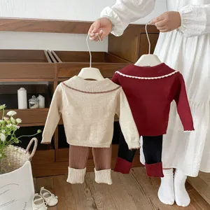 Close-up detail of toddler knit sweater set with contrast collar and ribbed leggings.