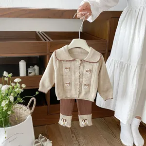 Infant knit cardigan and pants set detail, beige and brown toddler outfit with cute appliques.