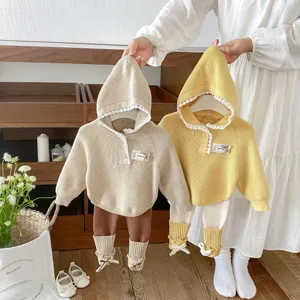 Infant knitted hooded sweater and leggings two-piece set with cute lace trim for baby girls.