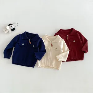 Detail view of infant knitted zip cardigan with lapel and pockets, soft texture close-up.