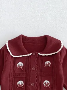 Toddler knitted cardigan detail view, sweet style maroon baby coat with white trim collar.