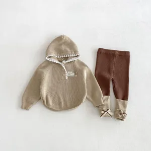 Details of baby knit sweater and leggings set, featuring cute lace trim and lovely bow cuffs.
