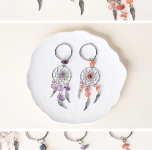 Detailed shot of crystal dreamcatcher keychains with purple and pink gemstone beads.