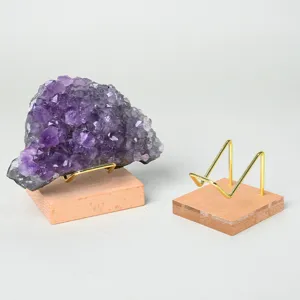 Natural amethyst crystal cluster with wooden base and metal display stand for home decoration.