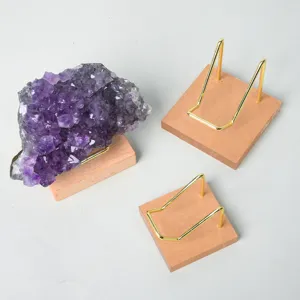 Natural amethyst cluster crystal mineral specimen displayed on a wooden metal display stand.