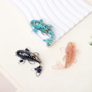 Crystal resin koi fish ornaments set of 3, gemstone chips and gold foil decor top view.