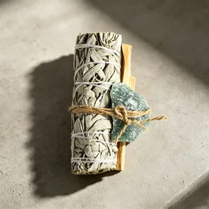 White sage smudge bundle with palo santo and green crystal stone for space cleansing healing
