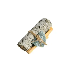White sage smudge bundle with Palo Santo wood and green crystal for space cleansing and yoga healing.