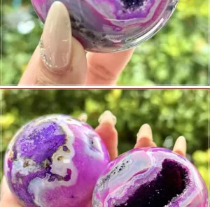 Detail shot of a polished purple agate crystal sphere showcasing natural druzy and vibrant patterns.