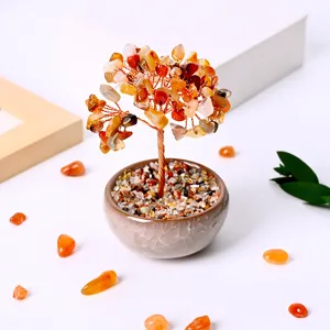 Detailed shot of handmade crystal money tree with colorful gemstone leaves and ceramic pot.