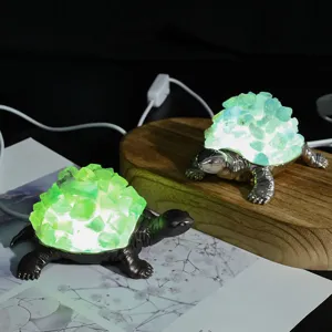 Detailed view of crystal turtle night light with glowing shell on wooden display stand.