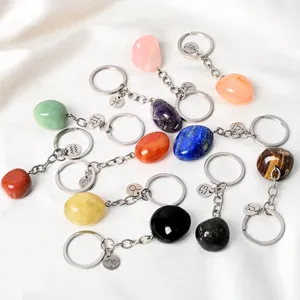 Natural crystal tumbled stone keychains with zodiac signs, perfect for car keys and bags.