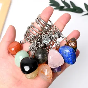 Natural crystal tumbled stone keychain with zodiac charm for car keys and bags detail view.