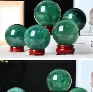 Detailed close-up view of natural green fluorite crystal sphere with wood base for home decor.