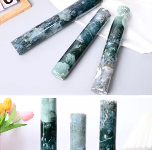 Moss agate crystal pillar detail showing natural green scenic texture and polished cylinder shape.