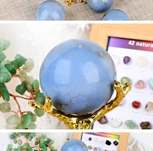 Close-up detail view of natural blue angelite crystal sphere on a gold branch stand.