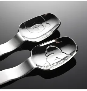 Stainless steel spoon detail showing cute cartoon embossed character pattern for kids.