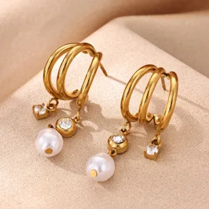 Detailed view of 18k gold plated stainless steel multi-layer hoop earrings with pearls and crystals.