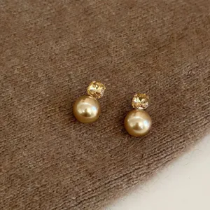 Champagne gold crystal and pearl stud earrings, elegant chic design fashion jewelry for women.